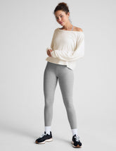 gray high-waisted midi length leggings with a crossover detail on the front waistband.
